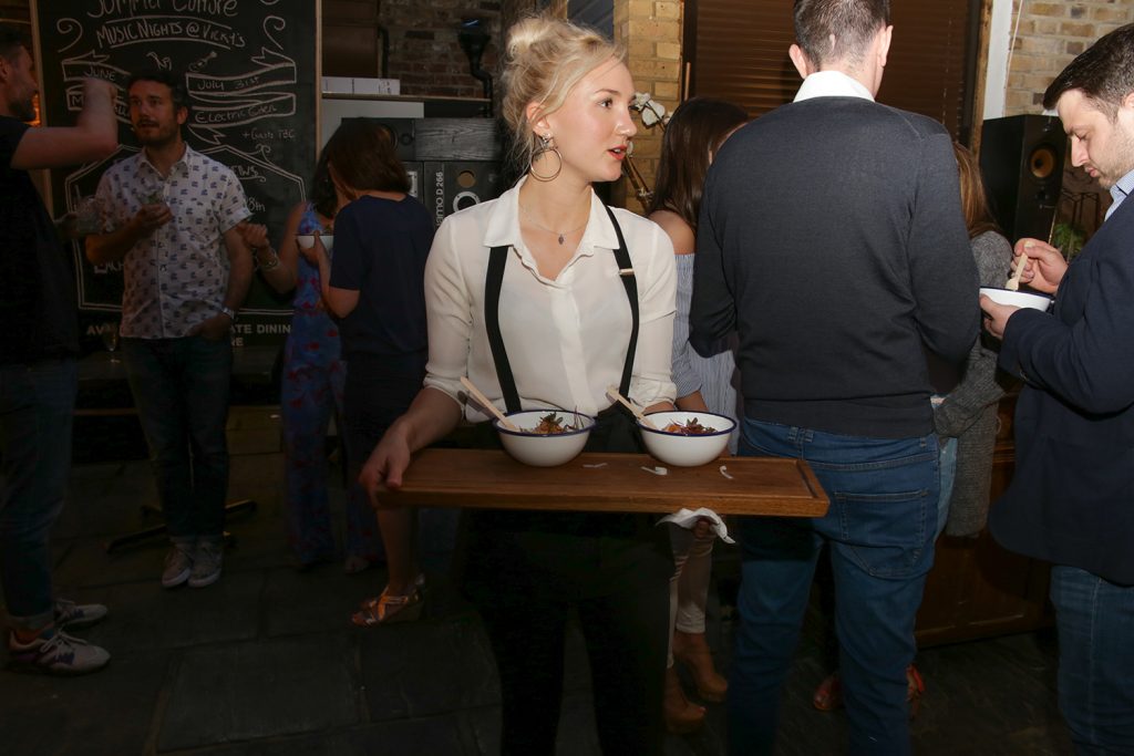Waitress at party serving dishes