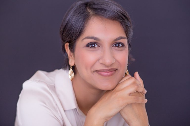 Asian woman with sparkly earrings staring into camera